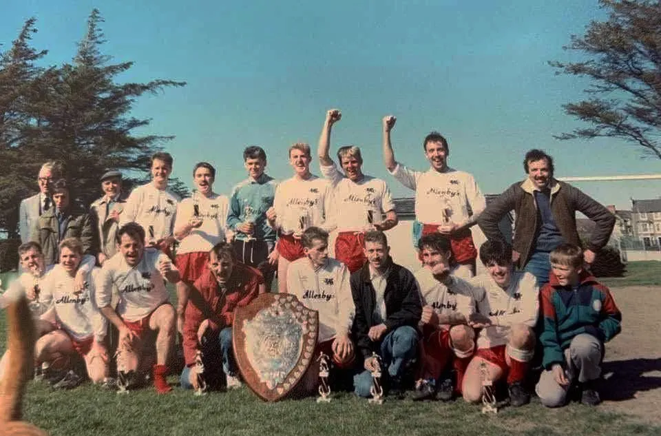 A Llanfairfechan Town side photographed with a cup and shield